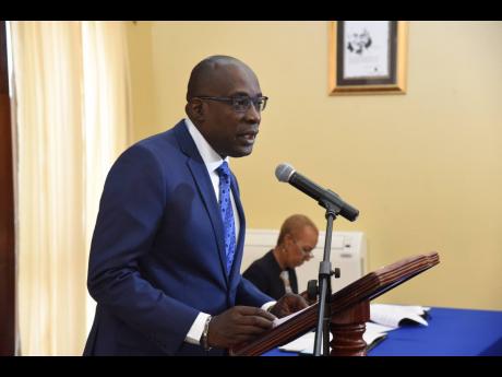 Ruel Reid,  minister of education, addresses the post-Cabinet meeting.