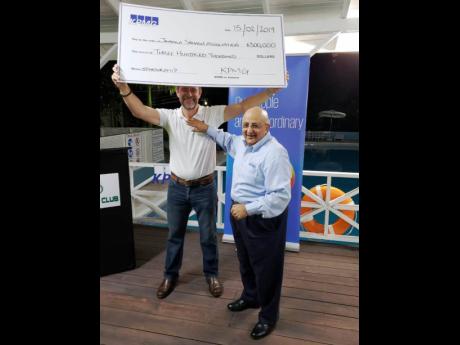 Chris Hind, president of the Jamaica Squash Association (left), happily accepts a sponsorship cheque for $300,000 from Tarun Handa, managing partner for KPMG in Jamaica, for the 20th annual KPMG Squash League. The 2019 edition of the flagship tournament was launched at the Liguanea Club on Saturday.