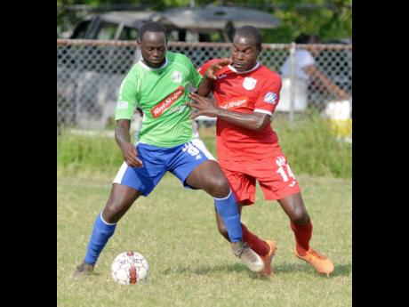 Dino Williams (left) of Montego Bay United getting the better of Ricardo Dennis of Boys’ Town during a tussle for the ball in a Red Stripe Premier League match at the Barbican Field on Wednesday, January, 17, 2018.