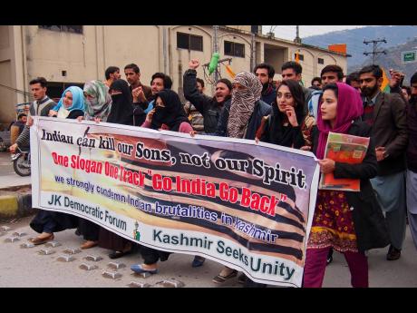 Kashmiri students rally against the Indian government in Muzaffarabad, capital of Pakistani Kashmir, yesterday. India has halted a key bus service with the Pakistani-controlled part of Kashmir, severing the only land route linking the divided Himalayan region.  
