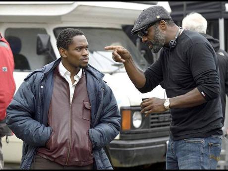 Aml Ameen (left) taking directions from Idris Elba during the filming of ‘Yardie’.