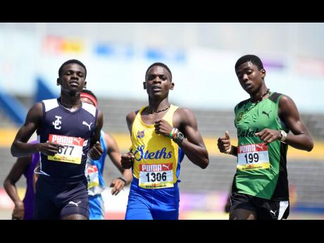 Fabian Campbell (left) of Jamaica College wins heat one of the class one boys 1500m event ahead of Kevroy Venson of Calabar (right) and Davian Gary of St Elizabeth Technical High at the ISSA/GraceKennedy Boys and Girls’ Athletics Championships at the National Stadium in Kingston on Wednesday March 27, 2019.