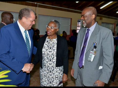 Credit: Contributed Minister of Industry, Commerce, Agriculture and Fisheries Audley Shaw (left) engages with Director, Environmental and Engineering Managers Limited, Ianthe Smith (centre); and Executive Director, Bureau of Standards Jamaica (BSJ), Hopeton Heron, at the launch of Jamaican Standard (JS) ISO 14005:2017 – Environmental Management Systems Guidelines, at the BSJ’s Winchester Road offices yesterday.