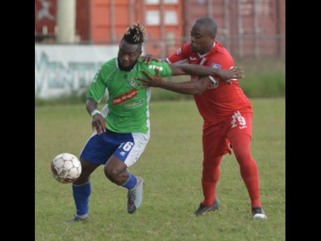 Former Montego Bay United striker Owayne Gordon (left) tries to get past Wayne Ellis from Boys’ Town during a Red Stripe Premier League football match at the Barbican Field in Kingston last January. Gordon now plies his trade for Oklahoma City Energy in the USL Championships.