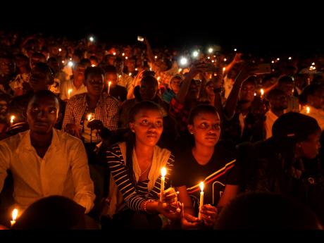 Rwandans sitting in the stands hold candles as part of a candlelit vigil during the memorial service held at Amahoro stadium in the capital Kigali, Rwanda on Sunday. Rwanda is commemorating the 25th anniversary of when the country descended into an orgy of violence in which some 800,000 Tutsis and moderate Hutus were massacred by the majority Hutu population over a 100-day period in what was the worst genocide in recent history. (AP)