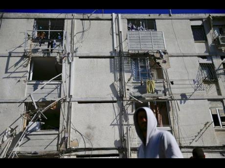 Damage is seen in a residential area after it was hit a by a rocket fired from Gaza in the southern Israeli city of Ashkelon, yesterday.  AP
