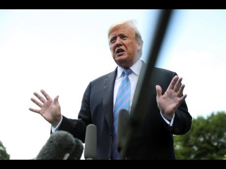 President Donald Trump speaks to members of the media on the South Lawn of the White House in Washington, Tuesday May 14, 2019, before boarding Marine One for a short trip to Andrews Air Force Base, Md., to travel to Louisiana. (AP Photo/Andrew Harnik)