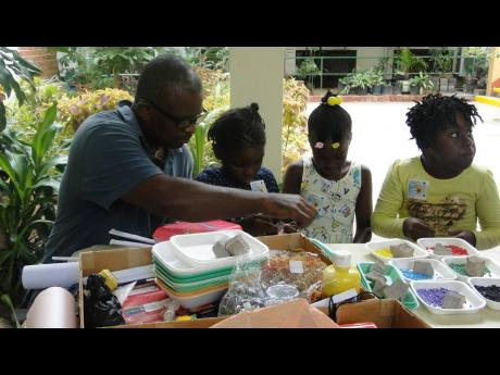 Valentine ‘Koda’ McLean teaching some youngsters to make jewellery.