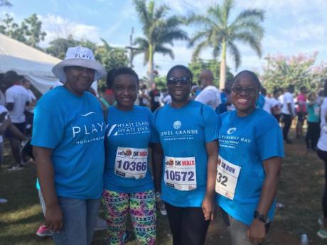 Playa Resorts JAMAICA team members from left Betty-Ann Brown, Dedra Brown, Stacie-Ann Earle, and Karlene Ritchie smile as they celebrate their finish at the recently held MoBay City Run. The Resorts have since 2019 increased their participation in health and wellness activities across the island.
