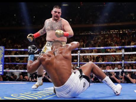 Andy Ruiz knocks down Anthony Joshua during the third round of a heavyweight title boxing match at Madison Square Garden in New York on Saturday. Ruiz won in the seventh round. 