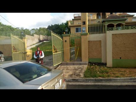 A police investigator at the apartment complex where Raymond ‘Moony’ Kerr’s body was discovered yesterday.