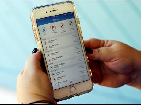 This August 1, 2017 file photo shows a call log displayed via an AT&T app on a cellphone in Orlando, Fla. New tools are coming to help fight robocall scams, but don’t expect unwanted calls to disappear. 