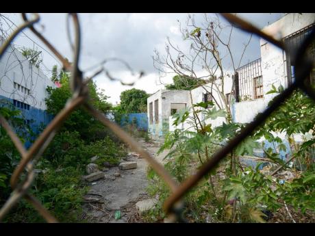 In this June 6, 2019, photograph, is seen a section of the burnt-out Hannah Town Police Station in west Kingston that was destroyed by firebombs during the May 2010 west Kingston upheaval. Residents are now demanding the restoration of the symbol of law and order. 