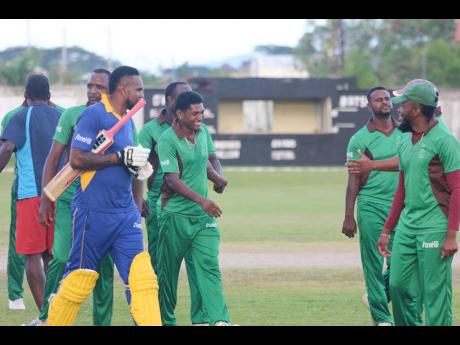 Credit: Lennox Aldred Captain Krishmar Santokie (third left) is congratulated by teammates following Clarendon’s win over St Elizabeth in the Jamaica Cricket Association T20 Bashment tournament at Chedwin Park, St Catherine, at the weekend.