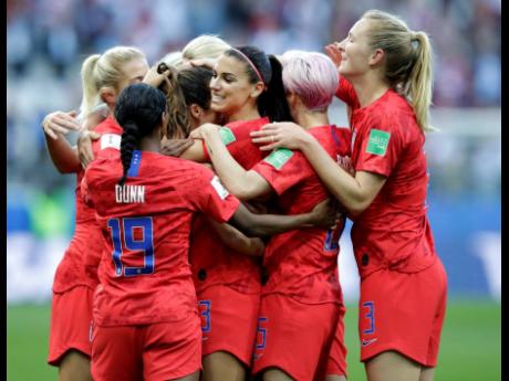 Credit: Alessandra Tarantino United States’ Alex Morgan (centre) celebrates after scoring the opening goal during their 13-0 rout of Thailand in Group F of the FIFA Women’s World Cup at the Stade Auguste-Delaune in Reims, France, yesterday.