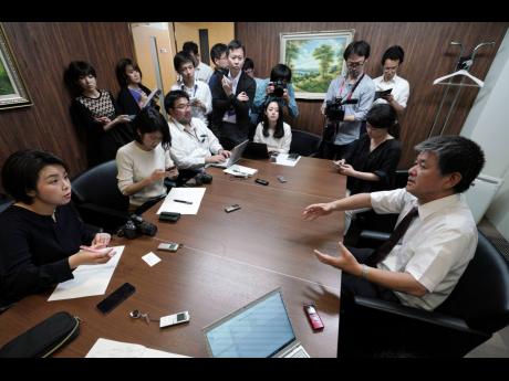 Michio Yube (right), director and general manager at the Kikuka Sankyo Co Ltd, speaks to the media at Kikuka Sankyo Co Ltd yesterday in Tokyo after one of their ships, the ‘Kokuka Courageous’, was attacked near the Strait of Hormuz. Two oil tankers near the strategic Strait of Hormuz were reportedly attacked on Thursday, an assault that left one ablaze and adrift as sailors were evacuated from both vessels and the US Navy rushed to assist amid heightened tensions between Washington and Tehran. 