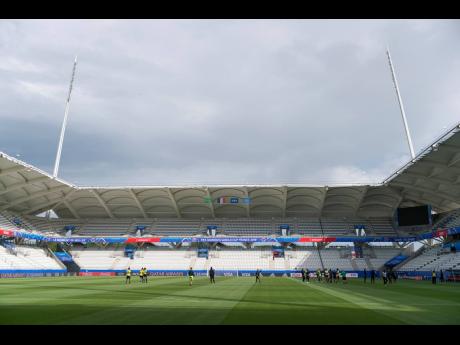Jamaica’s Reggae Girlz familarise themselves with the playing surface at the Stade Auguste-Delaune in Reims, France, yesterday. The team faces Italy in their second Group B fixture of the FIFA Women’s World Cup at the venue at 11 a.m. this morning.  