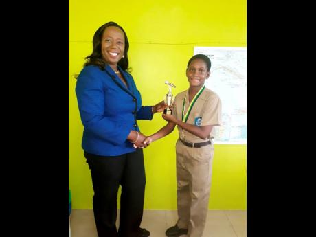 Gareth Stuart is congratulated by principal of Meadowbrook Preparatory School, Gloria Francis.