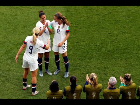 United States’ Carli Lloyd (top centre) celebrates with Lindsey Horan and Tierna Davidson (right) after scoring the opening goal during the FIFA Women’s World Cup Group F match against Chile at the Parc des Princes in Paris, France, yesterday. 