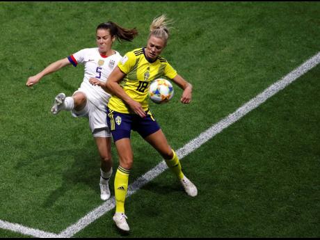 United States’ Kelley O Hara (left) and Sweden’s Fridolina Rolfo battle for ball possession during their FIFA Women’s World Cup Group F match at the Stade Oceane in Le Havre, France, yesterday. 