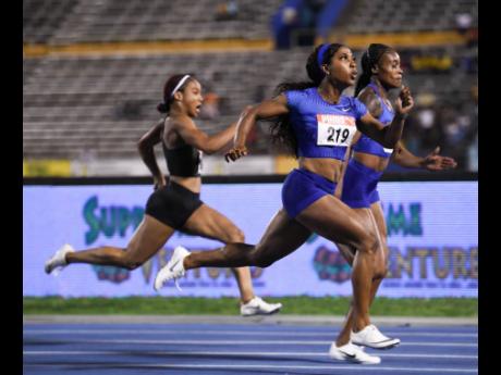 Elaine Thompson (back, right) edges Shelly-Ann Fraser-Pryce to take the Women’s 100m final at the JAAA/Supreme Ventures National Senior Athletics Championships at the Natioanl Stadium. Thompson clocked a world-leading 10.73 seconds for victory, same time as Fraser-Pryce, while Briana Williams (left) finished an impressive third in 10.94 seconds to set a World Under-18 record in the event. 
