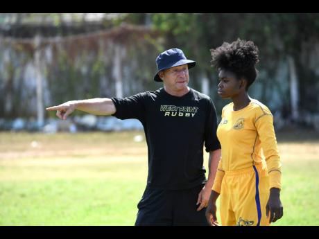 Credit: Ricardo Makyn Ricardo Makyn Chief Photo Editor
Head coach Stephen Lewis (right) issues instructions to a member of the Jamaica Rugby Union Lady Crocs team during a recent training session at Emmett Park.