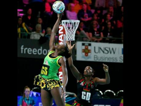 Credit: Contributed Jamaica goal shooter Shanice Beckford (left) in action against Malawi during the Fast5 Netball World Series on Friday, October 27, 2017.