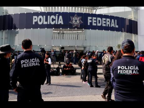 Credit: The Associated Press Striking police continue to hold a federal police command centre in the Iztapalapa borough, Mexico City, on Thursday, July 4, to protest against plans to force them into the newly formed National Guard. On Wednesday, federal police held the command centre and blocked key highways around the capital. They expressed concerns about potentially losing their salaries, benefits and seniority if they transferred to the National Guard and being left unemployed if they don’t join the new force.