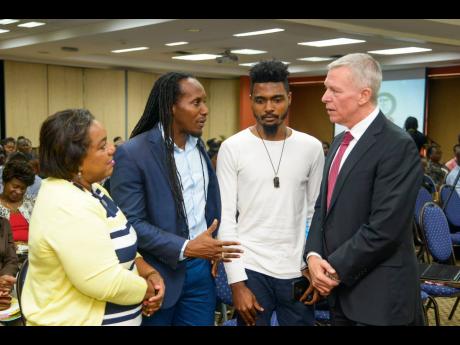 From left: Child Protection and Family Services Agency CEO Rosalee Gage-Grey, Junior Youth Minister Alando Terrelonge, Jamaicans for Justice Executive Director Rodje Malcolm, and Walter Bernyck, counsellor and head of development cooperation, High Commission of Canada, in conversation at a Jamaicans for Justice child-protection seminar and booklet launch at The UWI Regional Headquarters on Thursday. 