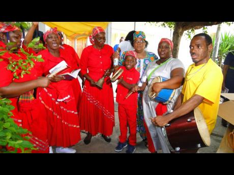 Some members of Denham Town’s Mount Carmel Revival Mission Church participate in the African Caribbean Institute of Jamaica/Jamaica Memory Bank Revival  tribute to former Prime Minister Edward Seaga in downtown Kingston on June 10.