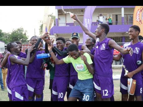 Kingston College players celebrate their win of the first Yardie Sports Challenge Cup, held on the school grounds on Sunday. 