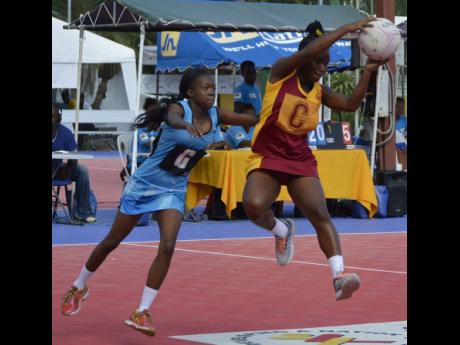 Springers’ Sierra Coward (left) puts pressure on Holmwood Technical’s Ryoho Jones during their semi-final matchup of the AFNA Champion of Champions High School Netball Tournament held at the Leila Robinson Court on July 20, 2018. Holmwood won 45-14.