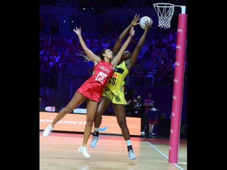 Credit: Collin Reid Sunshine Girls captain Jhaniele Fowler (right) outstretches England Roses goal keeper Geva Mentor to claim the ball, before scoring a goal during their Group G Vitality Netball World Cup match at the M