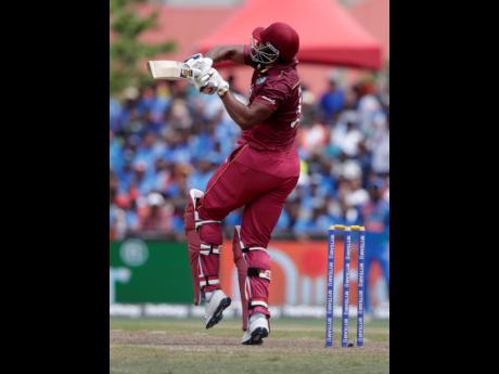 West Indies’ Kieron Pollard hit a six during the first Twenty20 international cricket match against India, yesterday, in Lauderhill, Florida. Pollard top-scored 49 as the West Indies lost by four wickets.