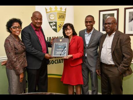 Camille Needham (third right), executive director of the Jamaica Hotel & Tourist Association (JHTA), presents Michael Ricketts (second left), president of the Jamaica Football Federation (JFF), with the ‘Abe Issa Award for Excellence’, designated for the Reggae Girlz at the JHTA 2019 Awards of Excellence. Sharing the moment are (from left) JHTA Councillors Prudence Simpson and Christopher Jarrett and JFF General Secretary Dalton Wint.