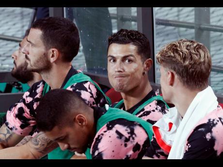Cristiano Ronaldo, (second from right) of Juventus sits on the bench prior to a friendly match against Team K League at the Seoul World Cup Stadium in Seoul, South Korea, Friday, July 26, 2019. 