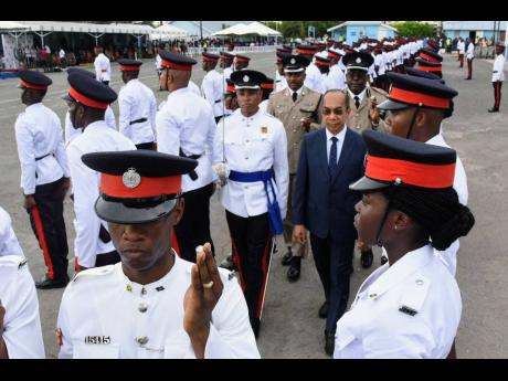 National Security Minister Dr Horace Chang (centre) conducts a review of 147 new police recruits graduating from the National Police College of Jamaica’s Harman Barracks Campus.