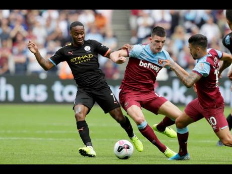 Credit: Kirsty Wigglesworth
Manchester City’s Raheem Sterling vies for the ball with West Ham’s Declan Rice (centre), and Manuel Lanzini (right) during the English Premier League football match between West Ham United and Manchester City at London stadium in London yesterday.