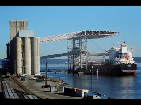 In this May 10, 2019, file photo a bulk carrier ship is loaded at the Temco grain terminal at the Port of Tacoma in Washington. US-China trade tensions are driving fears of recession.

