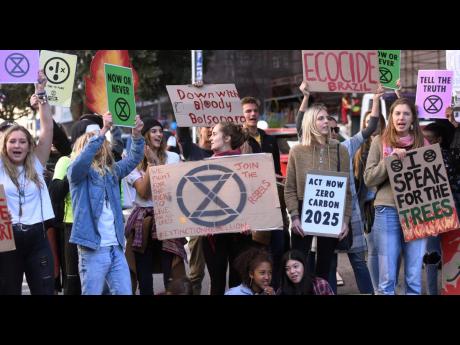 Credit: The Associated Press In this photo taken on Tuesday, August 27, people hold a placard demonstration in Cape Town, South Africa, in protest against fires burning in Brazil’s Amazon rainforest. Satellite images show a far greater number of fires burning on the African continent, but experts say the situation in Africa is different and not yet a growing problem.