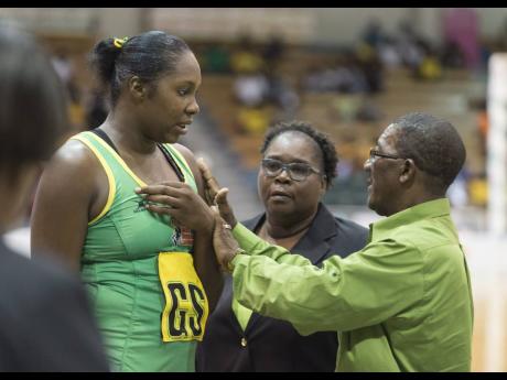 Credit: Gladstone Taylor Sunshine Girls assistant coach Winston Nevers (right) speaks with goal shooter Jhaniele Fowler (left), while looking on is Head Coach Marvette Anderson during a Lasco Sunshine Series match against the England Roses at the National Indoor Sports Centre on Saturday October 13, 2018.