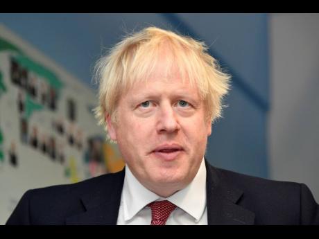 Britain's Prime Minister Boris Johnson visits Pimlico Primary school in London, Tuesday July 10, 2018, with Education Secretary Gavin Williamson to meet staff and students. (Toby Melville/Pool via AP)