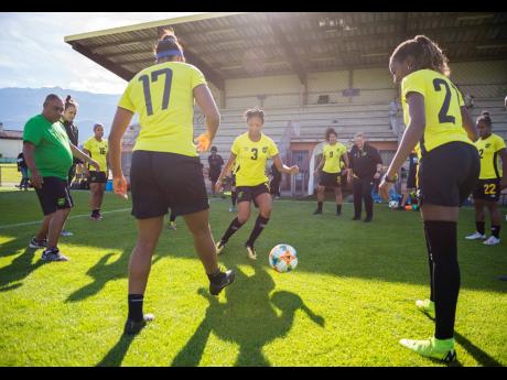 National senior women’s football team head coach Hue Menzies (left) leads his players in a training session at the FIFA Women’s World Cup in Grenoble, France, on Sunday, June 16.  Gladstone Taylor/Multimedia Photo Editor
