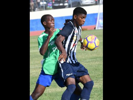 Sylvester Douglas (left) of Vauxhall and Alvarez Cooper of Jamaica College during their ISSA/Digicel Manning Cup match on Old Hope Road on Friday, September 13, 2019. JC won 2-0.