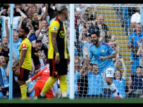  
Manchester City’s Bernardo Silva (right) celebrates after scoring his team’s sixth goal during the English Premier League match against Watford at Etihad Stadium in Manchester, England, yesterday. Manchester City won 8-0.