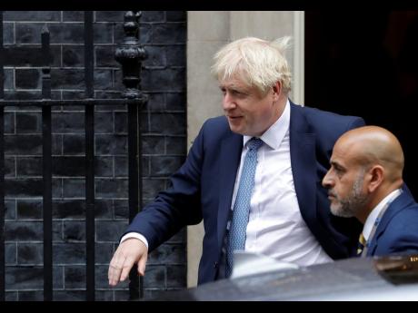 Britain’s Prime Minister Boris Johnson leaves 10 Downing Street in London, Thursday, Sept. 26, 2019. An unrepentant Prime Minister Boris Johnson brushed off cries of “Resign!” and dared his foes to try to topple him Wednesday at a raucous session of Parliament, a day after Britain’s highest court ruled he acted illegally in suspending the body ahead of the Brexit deadline. (AP Photo/Kirsty Wigglesworth)