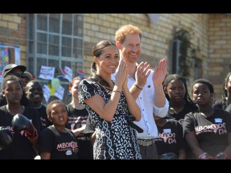 Britain’s Prince Harry and Meghan, Duchess of Sussex, greet youths on a visit to the Nyanga Methodist Church in Cape Town, South Africa, which houses a project where children are taught about their rights, self-awareness and safety, and are provided self-defence classes and female empowerment training to young girls in the community.  