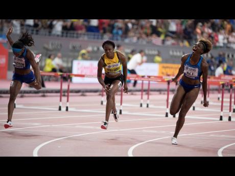 Jamaica’s Danielle Williams (centre) crosses the line in the women’s 100m hurdles final in third place behind winner Nia Ali (right) and runner up Kendra Harrison, both of the United States during the final day of the IAAF World Championships at the Khalifa International Stadium in Doha, Qatar yesterday.