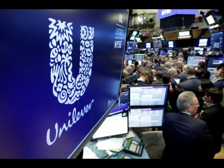 Credit: AP In this 2018 photo, the logo for Unilever appears above a trading post on the floor of the New York Stock Exchange.