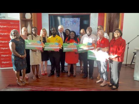 Digicel Foundation Board of Directors pose with the 2019 Digicel 5K Run For Special Needs beneficiaries. From Left: (front) Karlene Dawson, Antonia Graham, Sandrea Long White, Pauline Murphy, Jason Ricketts, Antonica Gunter-Gayle, Orville Johnson, Hilary Sherlock, Jean Lowrie-Chin; (behind) Denis O’Brien, Marlene Wilson, Charmaine Daniels, and Monique McLeod.